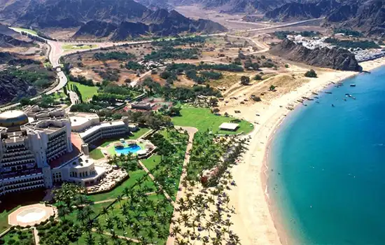 Exploring the Beaches of Oman: Which One Will You Enjoy the Most? 6 Al Bustan Beach, a paradise in the heart of Oman, with white sands, turquoise waters, and lush gardens.