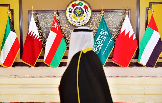 A Gulf Cooperation Council (GCC) summit setup with flags of Oman, Saudi Arabia, UAE, Qatar, Kuwait, and Bahrain.