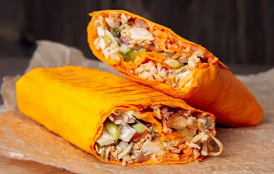 The History of Shawarma in the Gulf and Its Arrival in Oman 1 Image of two delicious shawarma pieces wrapped in brown paper.